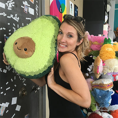 Image shows a woman holding the stuffed avocado. It is about the size of her torso.