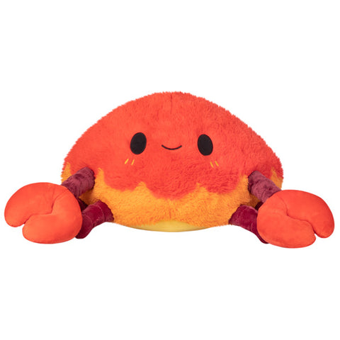 A plush toy resembling a crab with an orange and purple design, featuring a smiling face and claws.