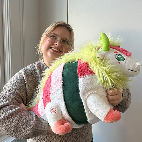 Image shows a woman holding the stuffed dragon sushi roll. It is about the size of her torso.