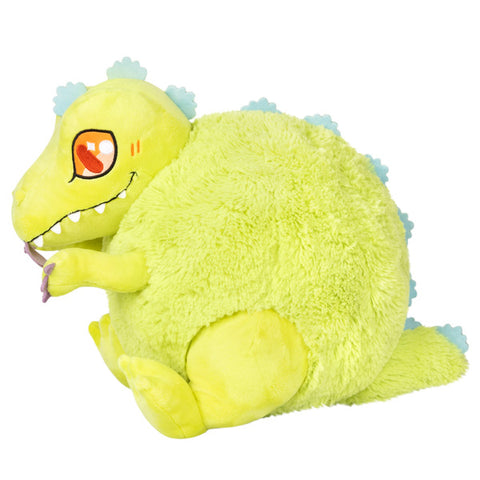 A side view of the plush Reptar. Its body is very round.