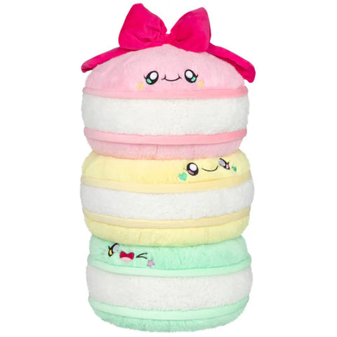 Image shows a stack of stuffed Macarons - one mint, one yellow, one pink, with a red bow on top.