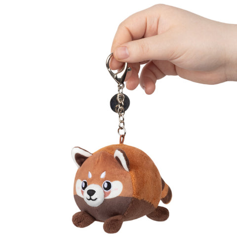 Image shows a round stuffed Red Panda hanging from a silver clip keychain