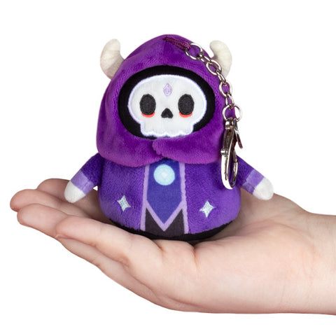 Image shows a purple stuffed Lich attached to a silver clip keychain