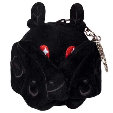 A front view of the plush mothman keychain with his wings closed