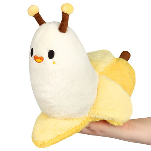 Image shows a stuffed "banana slug". The back half is a banana, and the front half is an open banana in the shape of a slug.