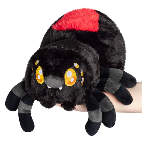 Image shows a stuffed black widow spider being held in someone's hand