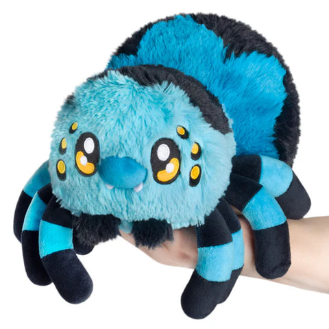 Image shows a hand holding a stuffed blue tarantula