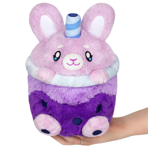 Image shows a cup of purple bubble tea with bunny feet and a bunny head instead of a lid.