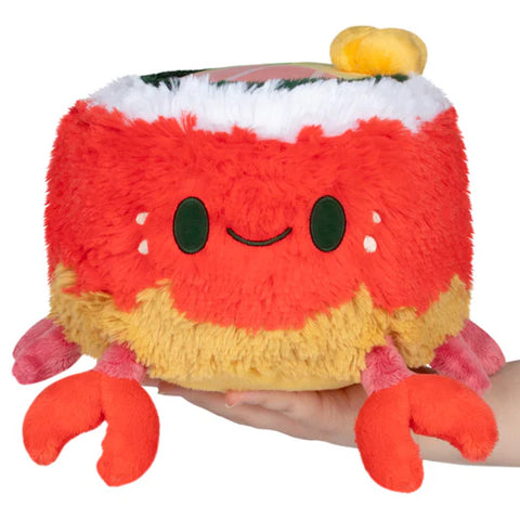 Image shows a stuffed crab and sushi hybrid. The crab is round and has sushi on its top.