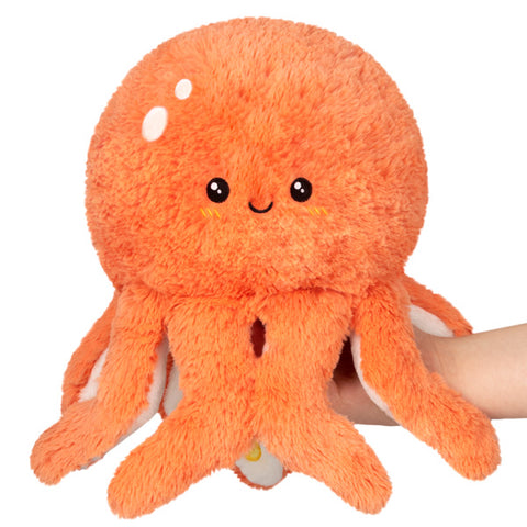 Image shows a stuffed coral-colored octopus