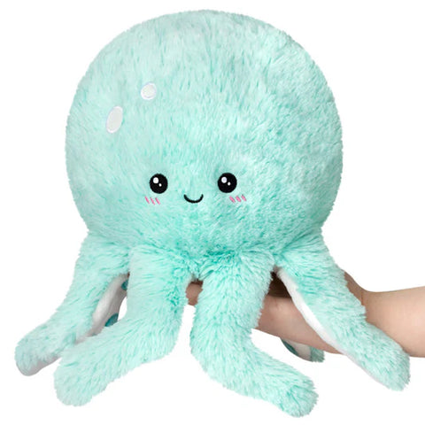 Image shows a mint-colored stuffed octopus with a smiley face