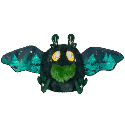The mothman has his wings open. A forest scene is on the inside of his wings.