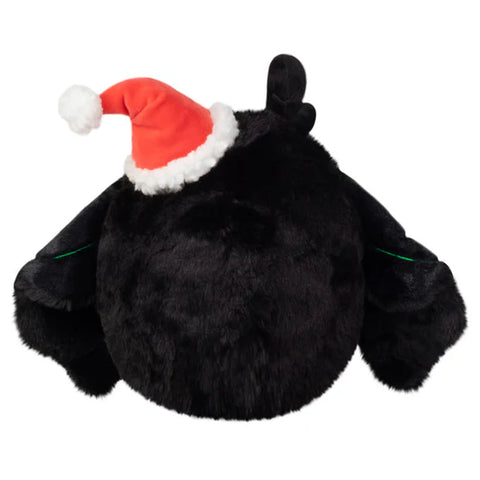 Image shows a back view of the stuffed baby mothman with his wings closed