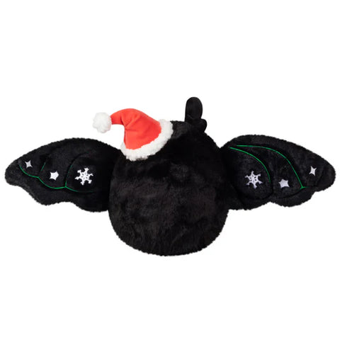 Image shows a back view of the festive baby mothman with his wings open, showing the embroidered snowflakes