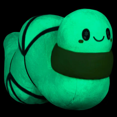 Glow in the dark worm plush on a black background
