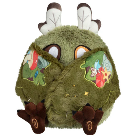 Image shows the stuffed goblincore baby mothman with his wings closed. They are held together by magnets.