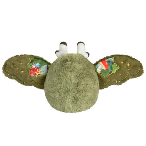 Image shows a back view of the stuffed goblincore baby mothman. His wings are open.