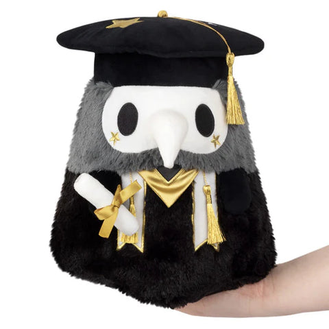 Image shows a stuffed graduation themed plague doctor. He wears a graduation cap and holds a diploma.