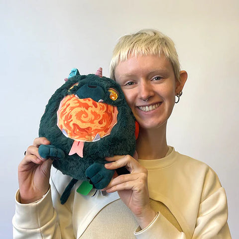 Image shows a woman holding the stuffed hellmouth up to her face. It is slightly larger than her head.