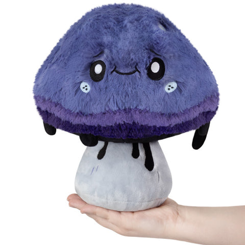 Image shows a stuffed purple inky cap mushroom with inky dripping off of its cap.