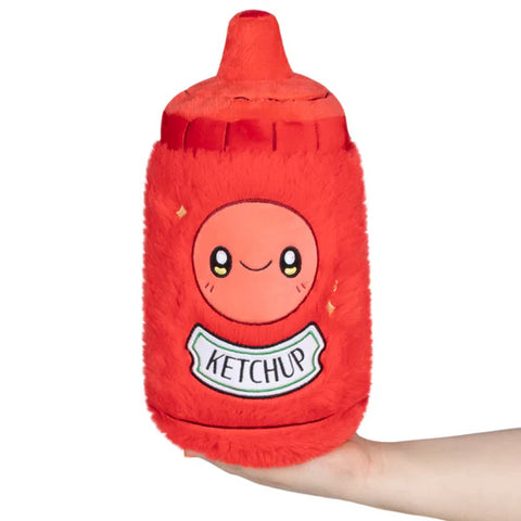 Image shows a stuffed ketchup bottle. It has a smiley face above the ketchup label.