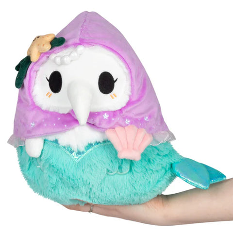 A mermaid-themed stuffed plague nurse. It has a lavender hood and a turquoise tail
