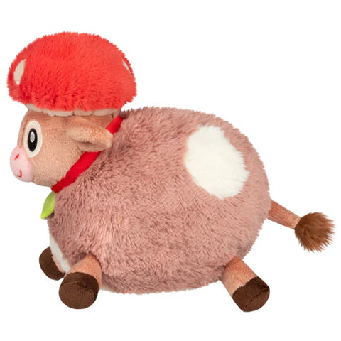 Image shows a side view of the stuffed mushroom hat cow