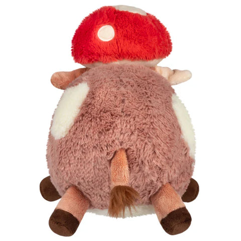Image shows a back view of the stuffed mushroom hat wearing cow