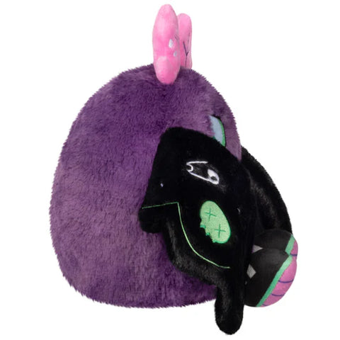 A side view of the plush neon punk baby mothman