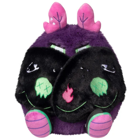 A front view of the plush neon punk baby mothman with its wings closed