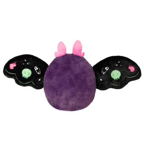 A back view of the plush neon punk baby mothman with his wings open