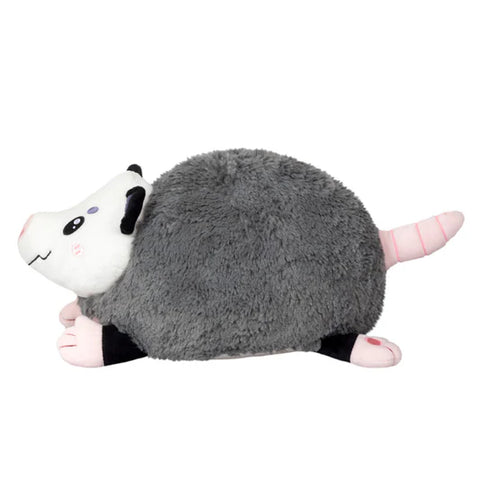 Image shows a side view of the round stuffed opossum