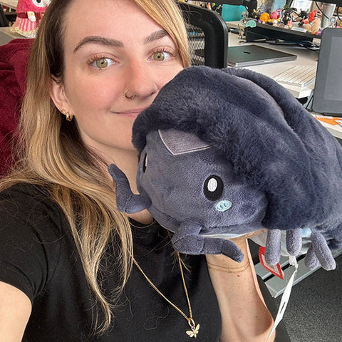 Image shows a woman holding the pillbug. It is slightly larger than her head.