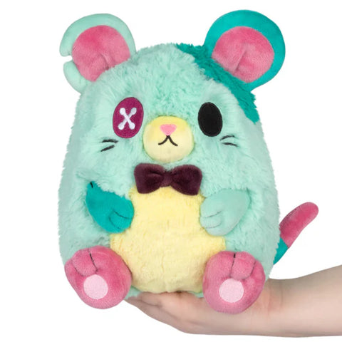 Image shows a mint-colored stuffed rat with a bowtie and a button for an eye. He has teal patches.