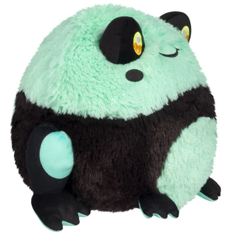 Side view of the plush teal and black frog on a white background