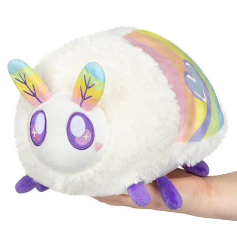 Image shows a white stuffed moth. It has pastel rainbow antennae and pastel rainbow wings.