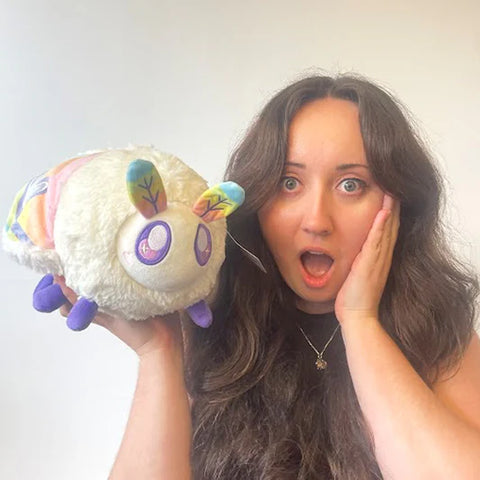 Image shows a woman holding the stuffed moth. It is about the size of her head.