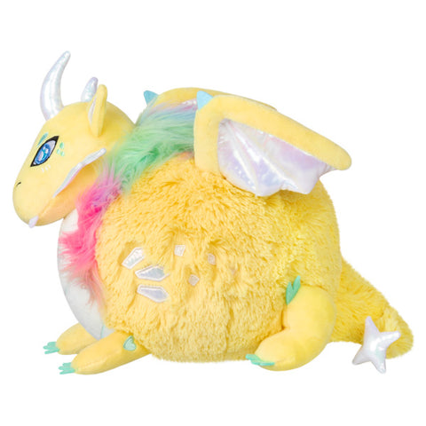 Image shows a side view of the stuffed dragon. It has a star at the base of its tail.