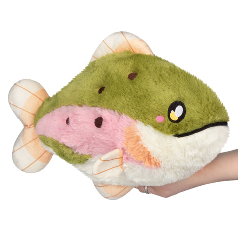 Plush rainbow trout held in a hand on a white background