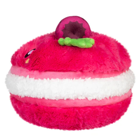 Image shows a side view of the stuffed raspberry macaron