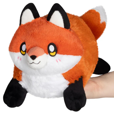 Image shows a stuffed red fox. It is very round.