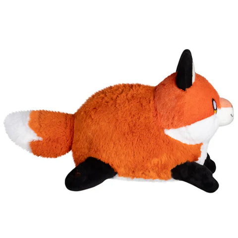 Image shows a side view of the stuffed red fox. It is very round.