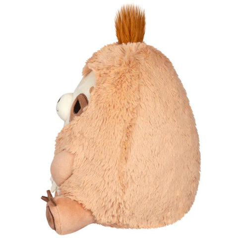 Image shows a side view of the stuffed sloth. Its body is round.