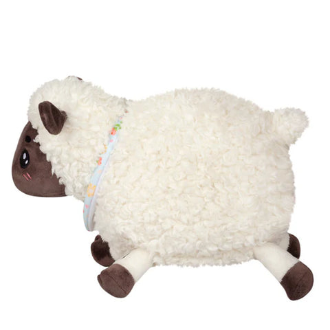 Image shows a side view of the stuffed lamb, emphasizing its chubbiness