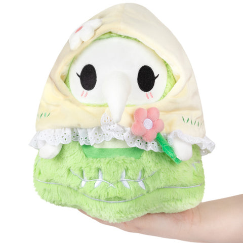 Image shows the spring plague nurse. She is pastel green and wearing a pastel yellow bonnet.
