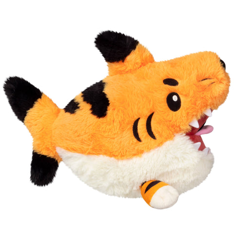 Plush shark toy with orange body, black fins, and white belly on a white background