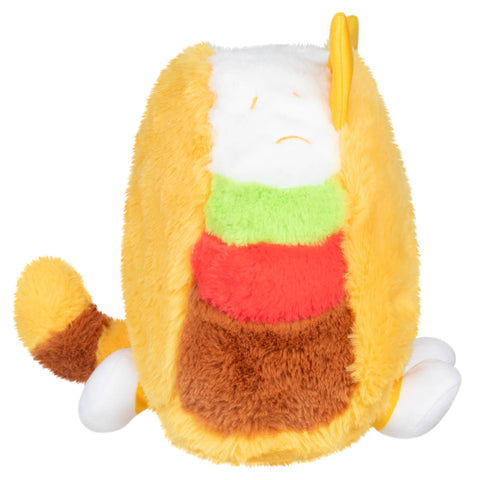 Side view of the plush taco cat. You can see its front and back paws and striped tail.