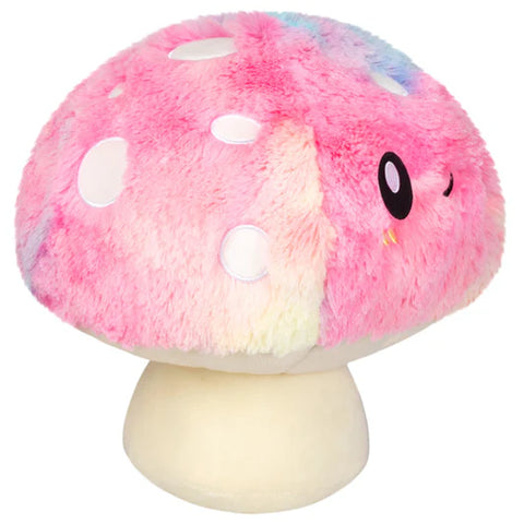 Side view of a Plush tie dye mushroom toy with a smiling face on a white background