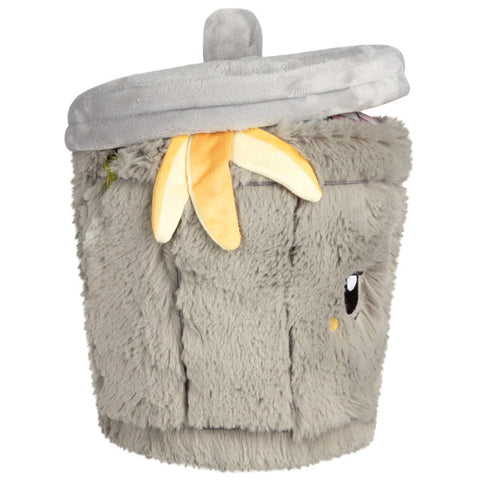 Image shows a side view of the stuffed trash can. It has a banana hanging out of the top.