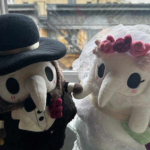 Image shows the stuffed bride plague nurse with a stuffed groom plague doctor